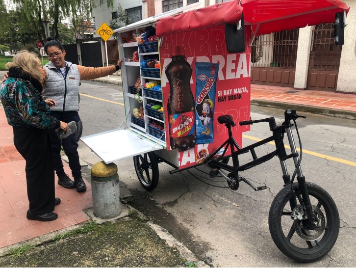 Cargo e-bike with a refrigerated container for delivering perishable food items.