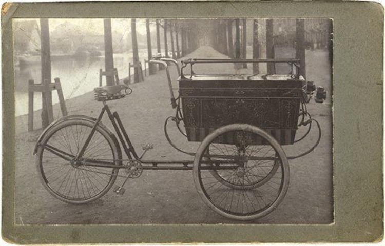 Historic black-and-white image of an early 20th-century cargo bicycle with a large
front storage box.